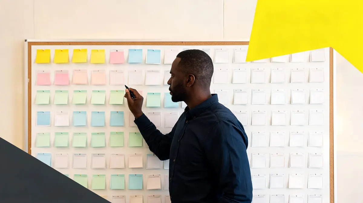 Sponsorship strategist reviewing a wall-sized pipeline board covered with sticky notes and printed proposal summaries in a brightly lit office